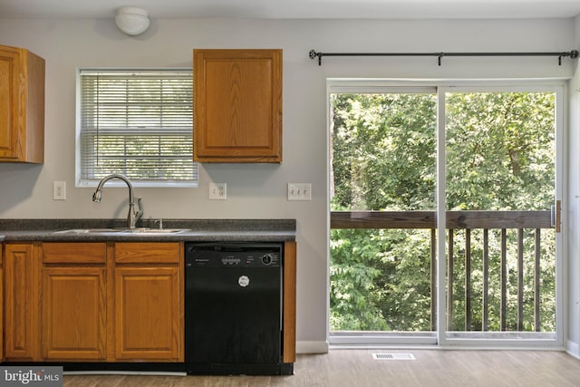 430 Cedar Creek Dr, Harpers Ferry, WV 25425 - kitchen featuring dishwasher, dark countertops, a sink, and brown cabinetry