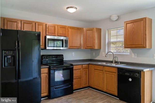 430 Cedar Creek Dr, Harpers Ferry, WV 25425 - kitchen with black appliances, a sink, dark countertops, wood finished floors, and brown cabinets