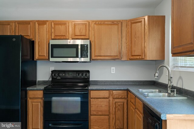 430 Cedar Creek Dr, Harpers Ferry, WV 25425 - kitchen with black appliances, a sink, dark countertops, and brown cabinets