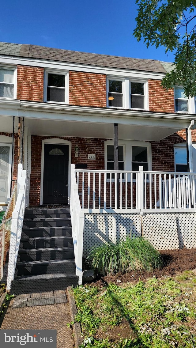 248 W Edgevale Rd, Baltimore, MD 21225 - view of front of house with brick siding and covered porch