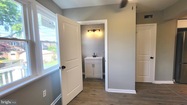 248 W Edgevale Rd, Baltimore, MD 21225 - bedroom with freestanding refrigerator, dark wood-type flooring, baseboards, and a sink