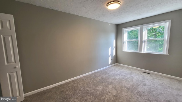 248 W Edgevale Rd, Baltimore, MD 21225 - empty room featuring a textured ceiling, carpet floors, and baseboards