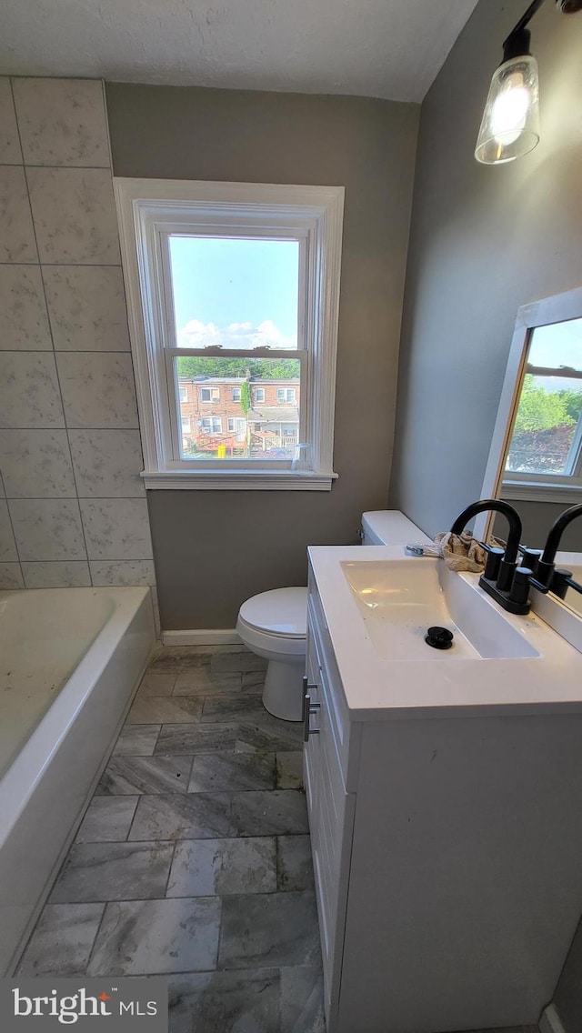 248 W Edgevale Rd, Baltimore, MD 21225 - bathroom featuring vanity, toilet, and a tub to relax in