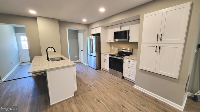 248 W Edgevale Rd, Baltimore, MD 21225 - kitchen with stainless steel appliances, a sink, light wood-style floors, baseboards, and recessed lighting