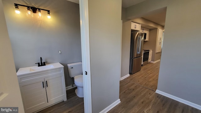 248 W Edgevale Rd, Baltimore, MD 21225 - bathroom featuring toilet, wood finished floors, vanity, and baseboards
