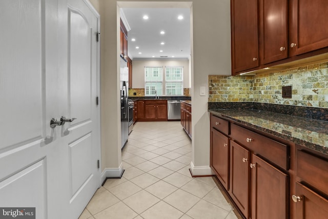 11249 Chase St Unit 100, Fulton, MD 20759 - kitchen featuring stainless steel dishwasher, light tile patterned flooring, decorative backsplash, dark stone countertops, and baseboards