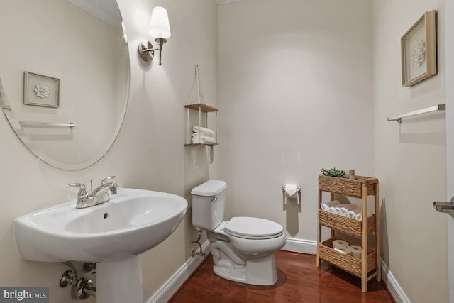 11249 Chase St Unit 100, Fulton, MD 20759 - bathroom with wood finished floors, toilet, baseboards, and a sink