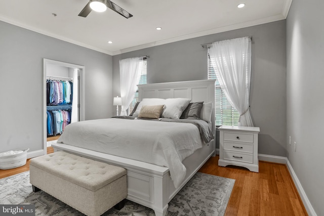 11249 Chase St Unit 100, Fulton, MD 20759 - bedroom with crown molding, wood finished floors, baseboards, a walk in closet, and recessed lighting