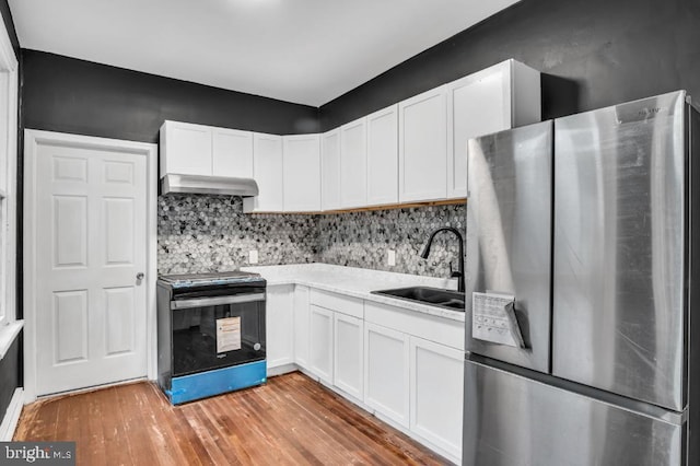 342 W Gay Ave, York, PA 17401 - kitchen with freestanding refrigerator, electric range oven, a sink, under cabinet range hood, and light wood-style flooring