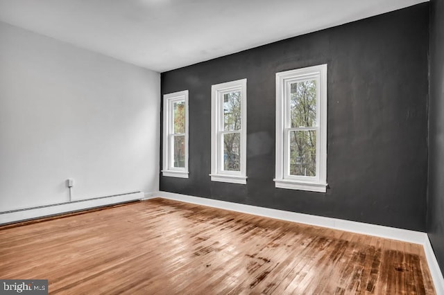 342 W Gay Ave, York, PA 17401 - spare room featuring wood finished floors, baseboards, and a baseboard radiator