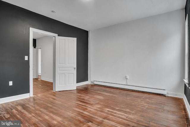 342 W Gay Ave, York, PA 17401 - empty room with baseboard heating, wood finished floors, and baseboards
