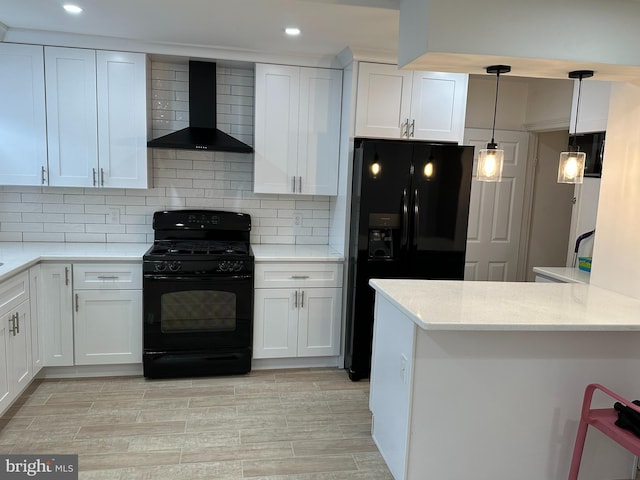 4304 Oakmont St, Philadelphia, PA 19136 - kitchen with black appliances, wall chimney range hood, white cabinets, recessed lighting, and tasteful backsplash