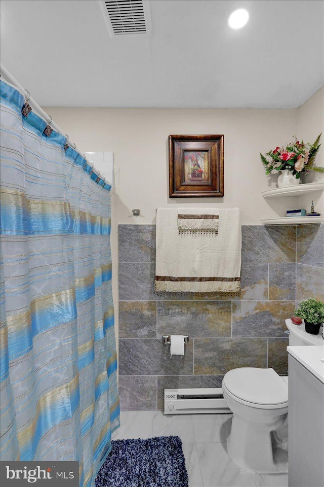 542 S 12th St, Reading, PA 19602 - bathroom with a baseboard radiator, toilet, marble look tiles, vanity, and tile walls