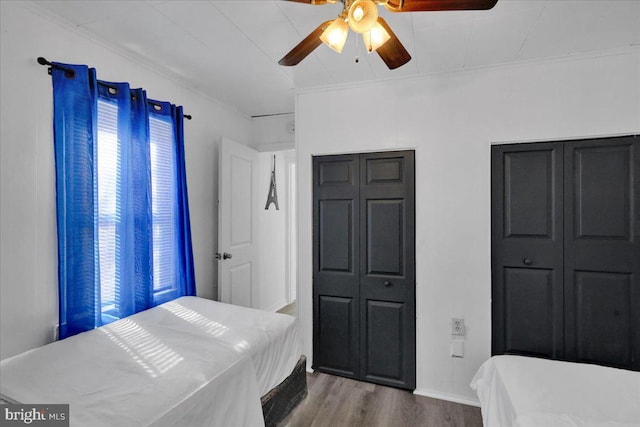 542 S 12th St, Reading, PA 19602 - bedroom featuring wood finished floors, ornamental molding, ceiling fan, baseboards, and multiple closets