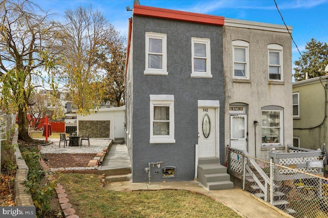 542 S 12th St, Reading, PA 19602 - multi unit property with stucco siding, a fire pit, and a patio area