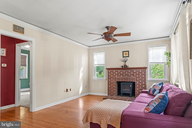 819 Elwood Rd, Hammonton, NJ 08037 - living room featuring a wood stove, wood finished floors, baseboards, crown molding, and ceiling fan