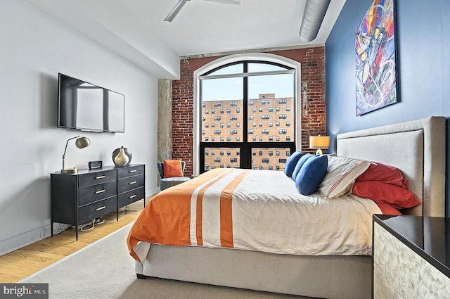 41 W Lemon St Unit 505, Lancaster, PA 17603 - bedroom featuring light wood finished floors, brick wall, ceiling fan, and baseboards