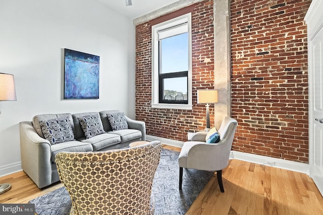 41 W Lemon St Unit 505, Lancaster, PA 17603 - living area featuring baseboards, brick wall, and wood finished floors