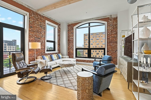 41 W Lemon St Unit 505, Lancaster, PA 17603 - living room with light wood-style flooring, brick wall, beamed ceiling, and a city view
