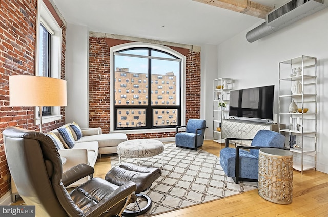 41 W Lemon St Unit 505, Lancaster, PA 17603 - living room featuring wood finished floors and brick wall