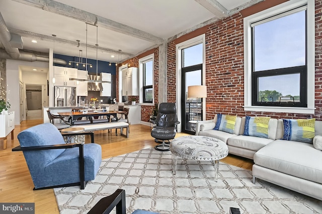 41 W Lemon St Unit 505, Lancaster, PA 17603 - living room featuring brick wall, beamed ceiling, and light wood finished floors
