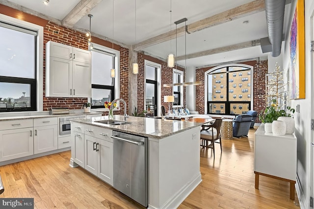 41 W Lemon St Unit 505, Lancaster, PA 17603 - kitchen featuring brick wall, a sink, dishwasher, beam ceiling, and open floor plan