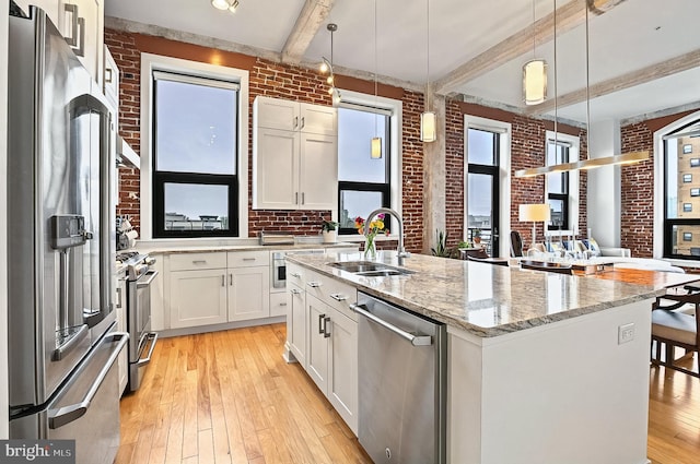41 W Lemon St Unit 505, Lancaster, PA 17603 - kitchen with appliances with stainless steel finishes, brick wall, light wood-style flooring, a sink, and beamed ceiling