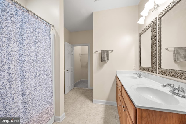 139 Flora Vista Ln, Woodstock, VA 22664 - bathroom featuring tile patterned flooring, double vanity, and baseboards
