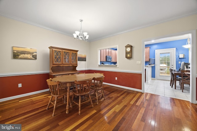 139 Flora Vista Ln, Woodstock, VA 22664 - dining area featuring a chandelier, ornamental molding, hardwood / wood-style floors, and baseboards