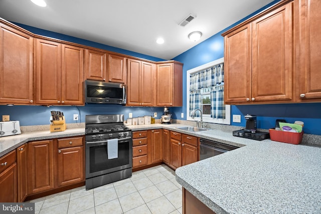 139 Flora Vista Ln, Woodstock, VA 22664 - kitchen with stainless steel appliances, a sink, brown cabinetry, light tile patterned floors, and recessed lighting