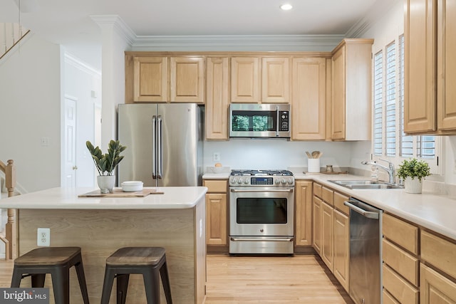 1251 Wild Hawthorn Way, Reston, VA 20194 - kitchen featuring appliances with stainless steel finishes, light brown cabinetry, a sink, a kitchen breakfast bar, and light wood-style floors