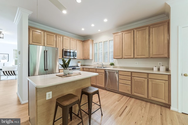1251 Wild Hawthorn Way, Reston, VA 20194 - kitchen featuring stainless steel appliances, light brown cabinets, ornamental molding, a kitchen bar, and light wood finished floors