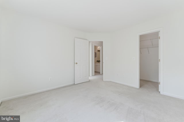 1251 Wild Hawthorn Way, Reston, VA 20194 - unfurnished bedroom with light carpet, a spacious closet, baseboards, and a closet