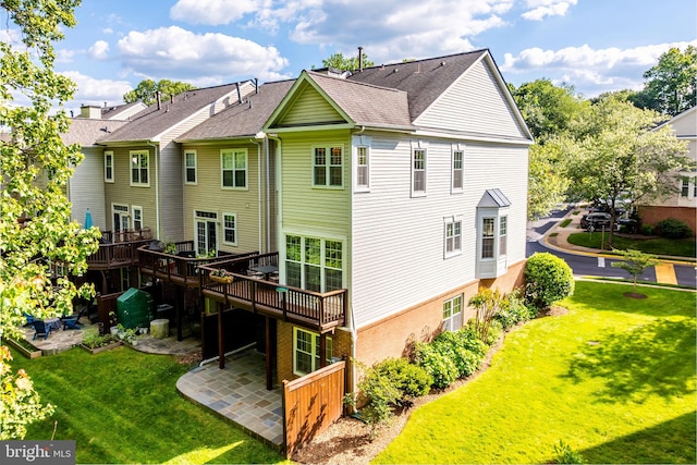 1251 Wild Hawthorn Way, Reston, VA 20194 - rear view of house with a lawn, a shingled roof, a wooden deck, and brick siding