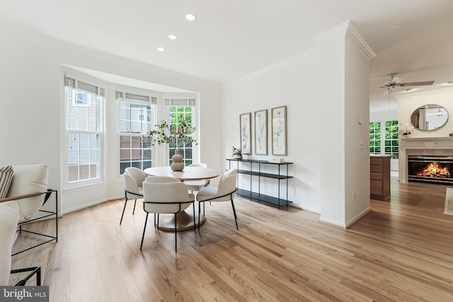 1251 Wild Hawthorn Way, Reston, VA 20194 - dining room with ornamental molding, light wood-style flooring, baseboards, healthy amount of natural light, and a glass covered fireplace