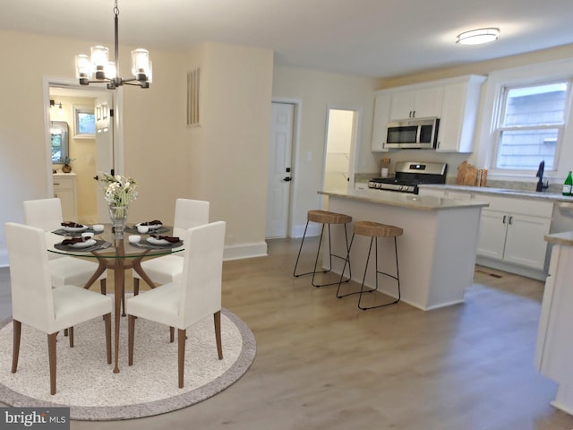 22 Leeway Rd, Baltimore, MD 21222 - dining space featuring a chandelier and light wood finished floors