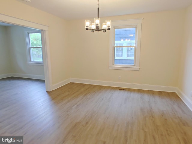 22 Leeway Rd, Baltimore, MD 21222 - spare room featuring a chandelier, wood finished floors, and baseboards