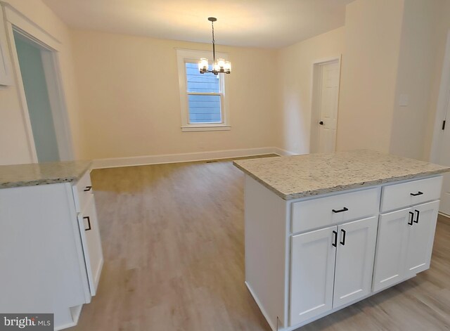 22 Leeway Rd, Baltimore, MD 21222 - kitchen featuring light wood-style flooring, a chandelier, a center island, decorative light fixtures, and white cabinets