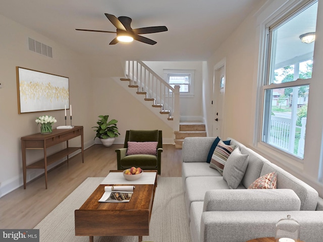 22 Leeway Rd, Baltimore, MD 21222 - living area featuring stairway, light wood finished floors, a ceiling fan, and baseboards