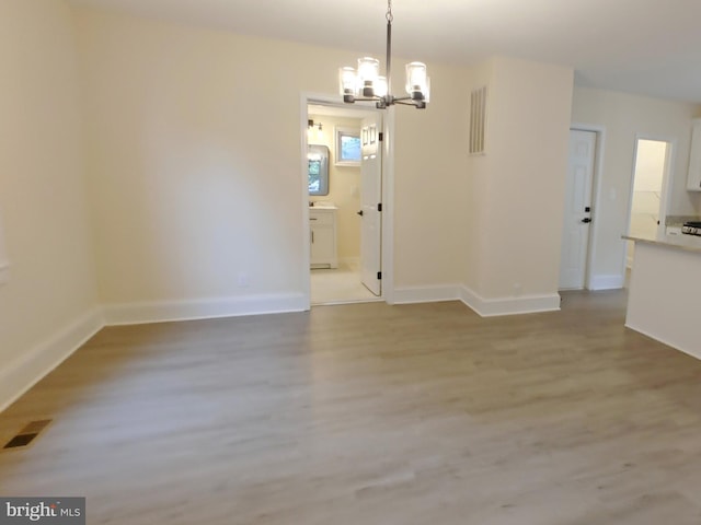22 Leeway Rd, Baltimore, MD 21222 - unfurnished dining area featuring a chandelier, light wood finished floors, and baseboards