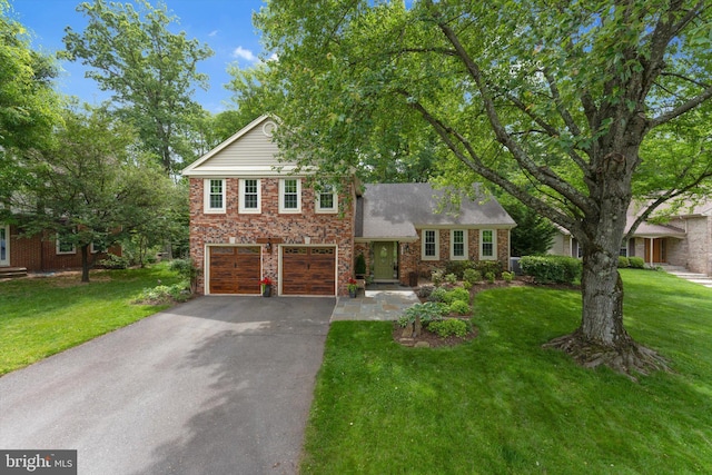 12695 Kettering Dr, Herndon, VA 20171 - view of front of house featuring driveway, an attached garage, a front yard, and brick siding