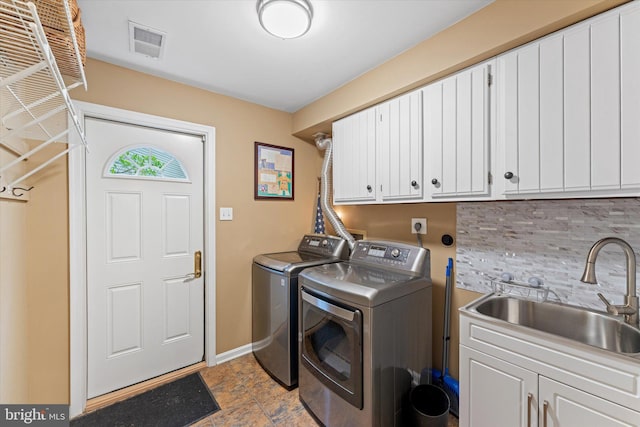 12695 Kettering Dr, Herndon, VA 20171 - washroom with cabinet space, washing machine and dryer, baseboards, and light stone finish flooring