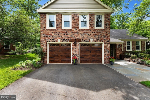 12695 Kettering Dr, Herndon, VA 20171 - view of front of house featuring driveway, an attached garage, brick siding, and a front yard