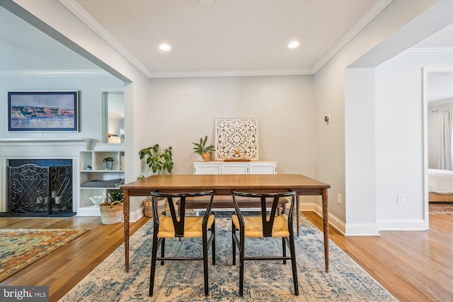 2709 Emmet Rd, Silver Spring, MD 20902 - dining room with light wood-style floors, baseboards, a fireplace, crown molding, and recessed lighting