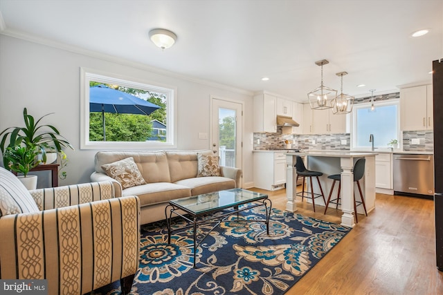 2709 Emmet Rd, Silver Spring, MD 20902 - living room featuring crown molding, light wood finished floors, a chandelier, and recessed lighting