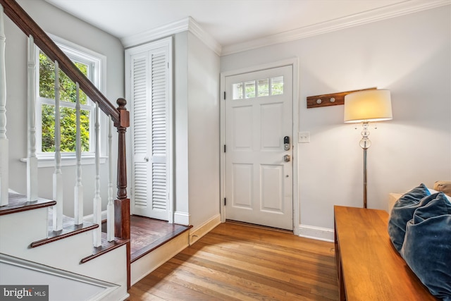2709 Emmet Rd, Silver Spring, MD 20902 - entrance foyer with light wood-style flooring, plenty of natural light, stairs, baseboards, and crown molding