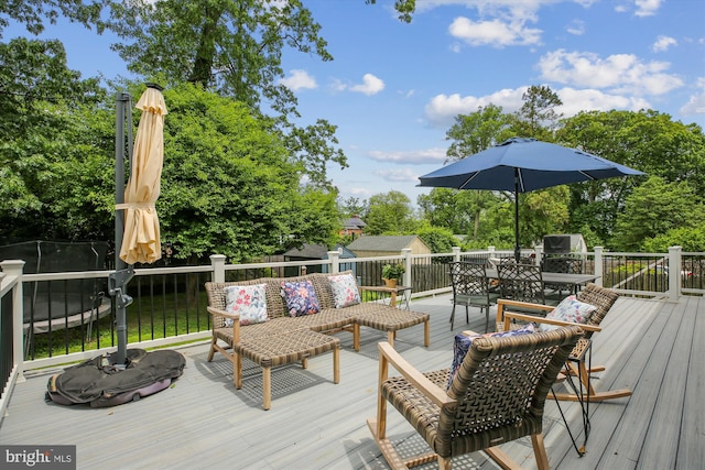 2709 Emmet Rd, Silver Spring, MD 20902 - deck with outdoor dining area, view of wooded area, and an outdoor hangout area