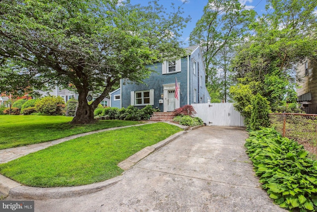 2709 Emmet Rd, Silver Spring, MD 20902 - view of front facade featuring driveway, brick siding, and a gate