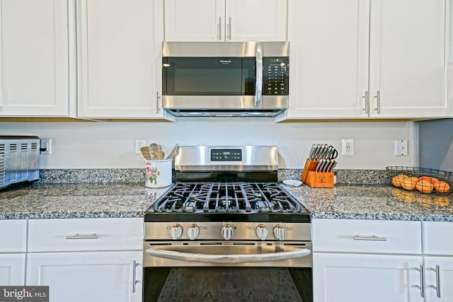 35290 Wright Way, Millsboro, DE 19966 - kitchen featuring appliances with stainless steel finishes, white cabinets, and dark stone countertops