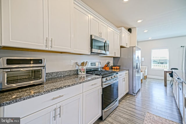 35290 Wright Way, Millsboro, DE 19966 - kitchen featuring stainless steel appliances, white cabinets, recessed lighting, dark stone countertops, and light wood-type flooring